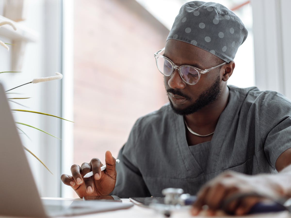 Clinician working at a laptop in a modern office