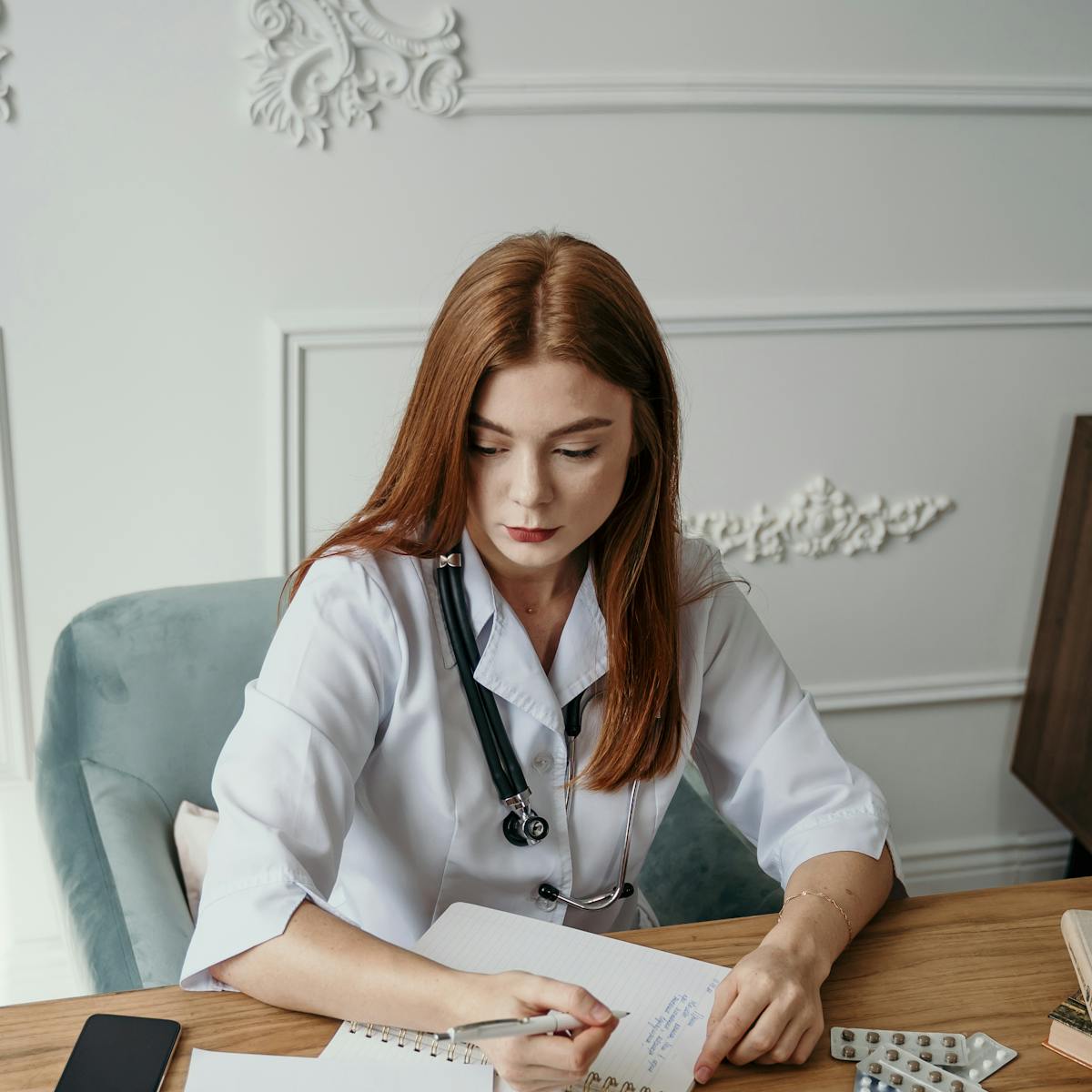 Doctor reviewing notes at their desk